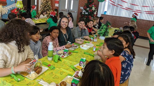 Students dress up and get served a fine meal. 